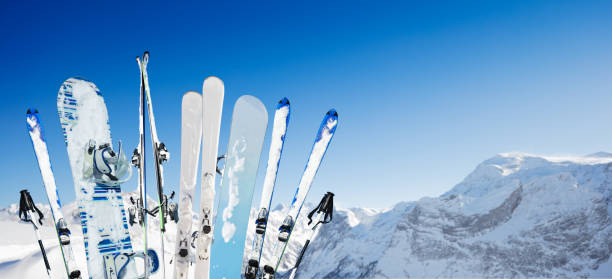 istock Many ski and snowboard equipment over mountain 1253390657