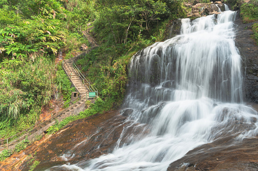 Strong water flow and steel-arched bridge at Silver Waterfall (Thac Bac waterfall) in Sapa,Lao Cai province,North Vietnam.