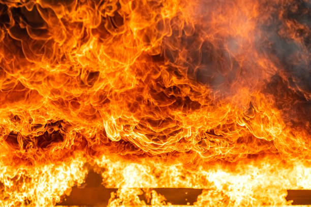 istock Fire flames engulfing from explosion and billowing inside burning premises. Blaze fire flames texture background. Firefighter on duty rescue and industrial safety concept. 1253392119