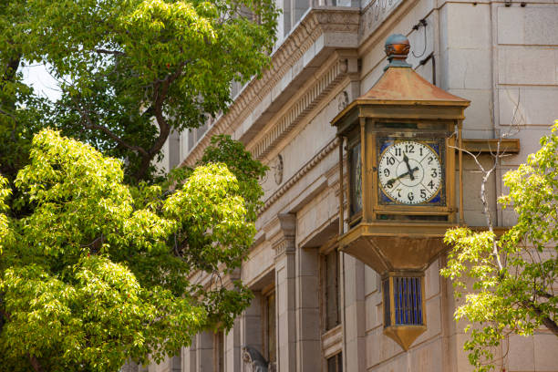 Whittier, California / USA - May 16, 2020: Sun shines on a historic clock in Uptown Whittier, California.