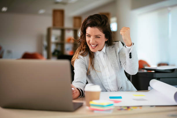 istock Businesswoman celebrating wining a new project 1253392981