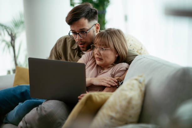 istock Young couple watching a movie on a laptop. 1253393406