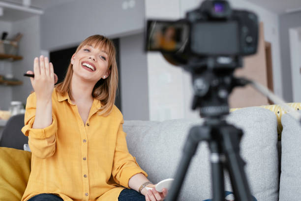 istock Young beautiful woman recording make up tutorial to share on social media. 1253394291