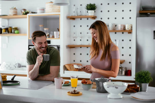 istock Loving couple eating sandwiches in the kitchen. 1253395265