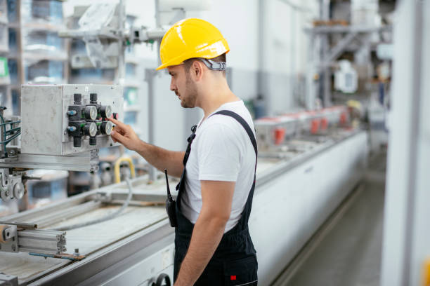 istock Factory worker. Man working on the cables and wires. 1253395689