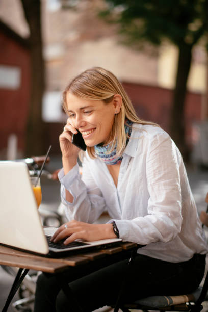 istock Young beautiful woman in cafe working on computer. 1253395835