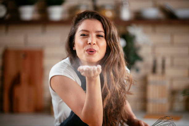 istock Beautiful girl playing with flour while cooking. 1253396720