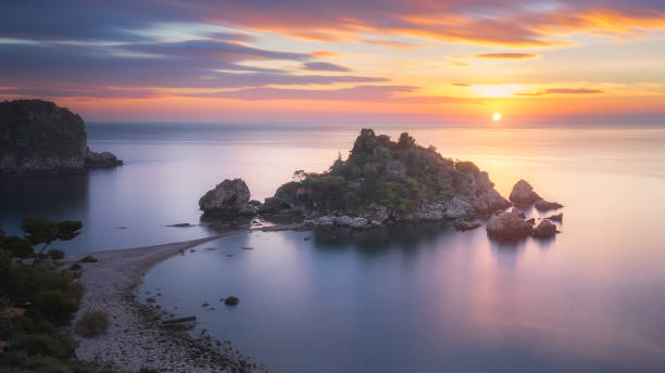 Sunrise at Isola Bella, Sicily, Italy A sunrise captured at the famous location called Isola Bella in Sicily, Italy. isola bella taormina stock pictures, royalty-free photos & images