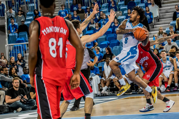 istock Basketball players chasing for ball 1253403369