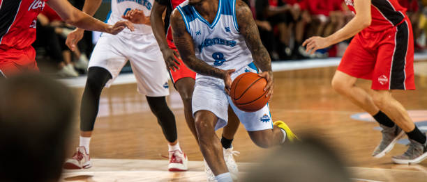 istock Basketball players chasing for ball 1253403929