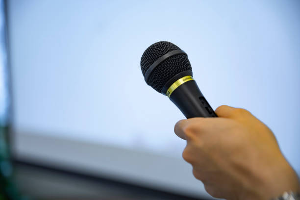 istock A microphone with left hand behind the white board at the office 1253405331