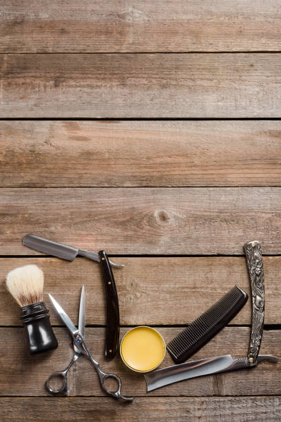istock Wax, vintage straight razors, a brush, scissors and a comb 1253406213