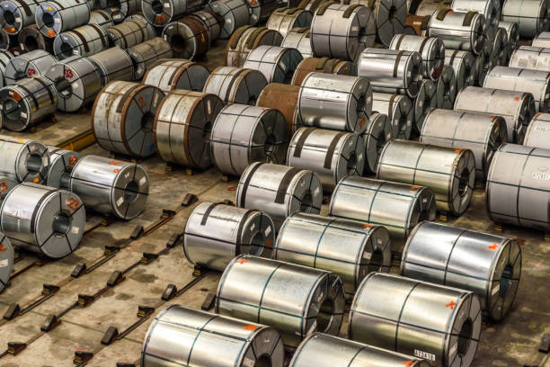 istock Raw material Handling: Steel coil storing inside a warehouse for exporting to automotive industry plant in black and white. 1253407315