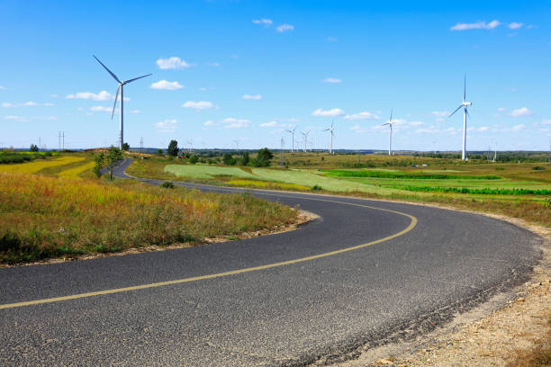 Asphalt road and wind turbines