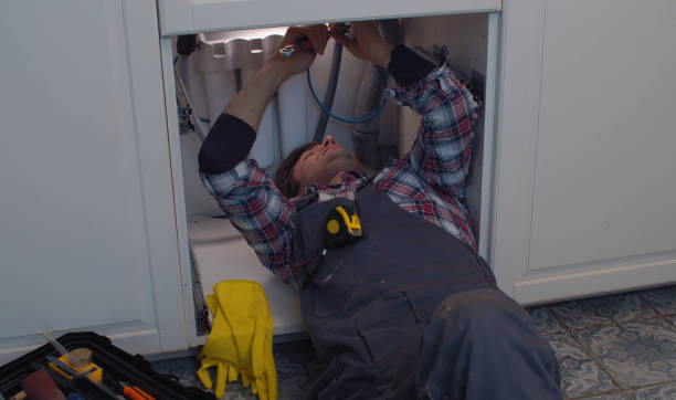 istock Plumber repairs a siphon leak in a kitchen sink 1253411300