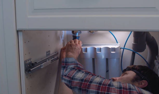 istock Plumber repairing water supply hose 1253411309