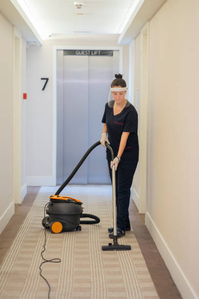 istock Maid vacuuming hotel corridor 1253412728