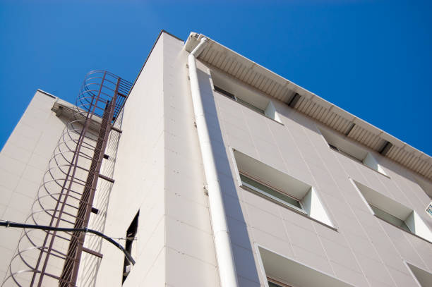istock fire metal staircase on a building tiled wall against a blue sky 1253412756