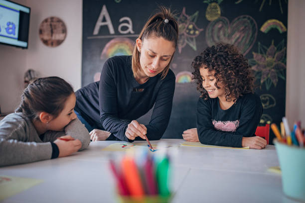 istock Two girls learning writing in preschool 1253415231