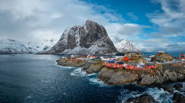 Panorama of Hamnoy fishing village with red rorbu houses in Norwegian fjord in winter. Lofoten Islands, Norway