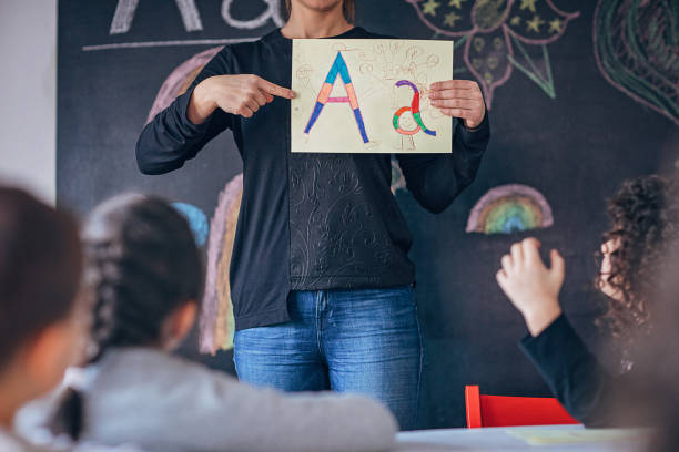 istock Preschool children learning letters 1253416431