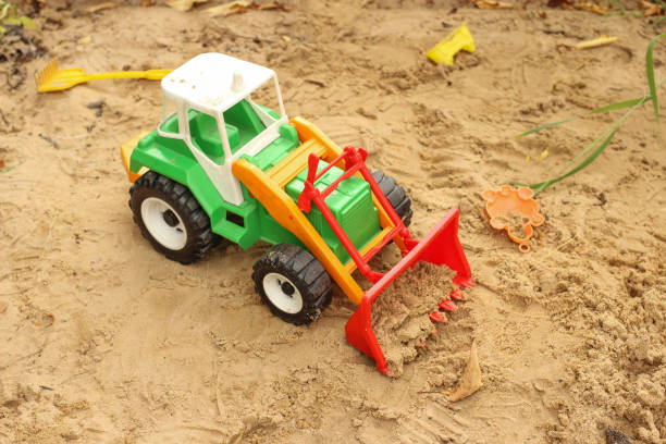 istock Toy tractor, excavator in the sandbox 1253417423