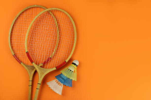 istock badminton rackets and shuttlecocks on a bright orange background 1253417569