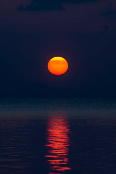 Big sun sky in blue hour at the lake.