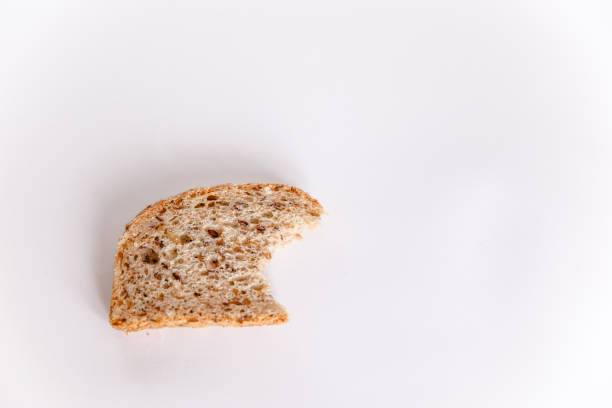 istock A bitten piece of bread with cereals on a white background 1253418499