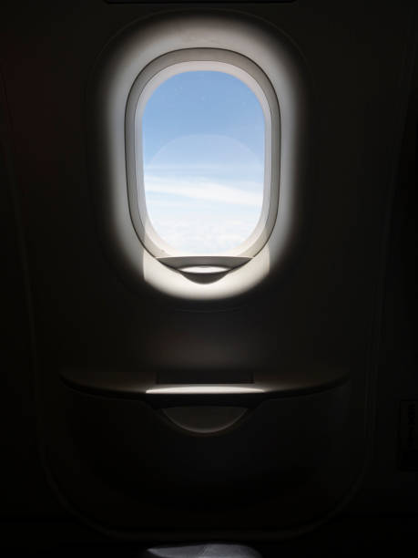 istock Low key photo of aircraft window frame with sky view. Copy space provided. 1253418666