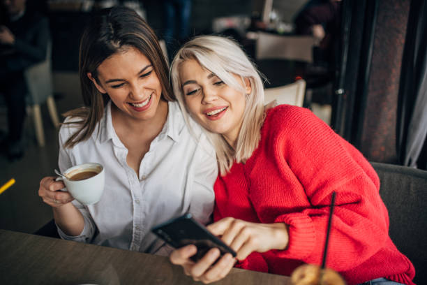 istock Two girlfriends sitting in the coffee shop 1253420344