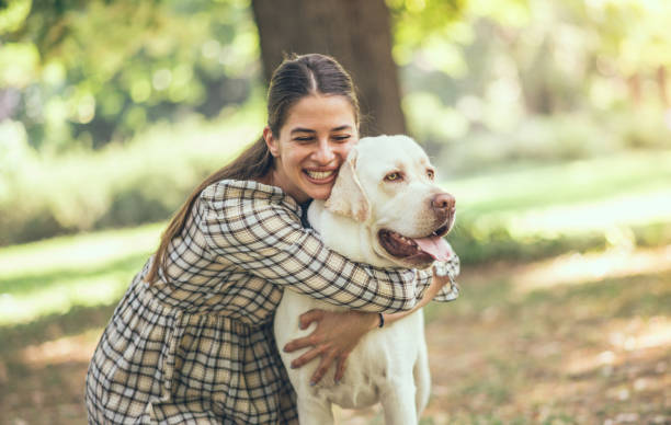 istock Young woman with dog 1253420642