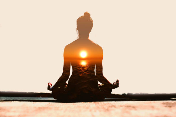 Yoga day concept. Multiple exposure image. Woman practicing yoga at sunset. stock photo