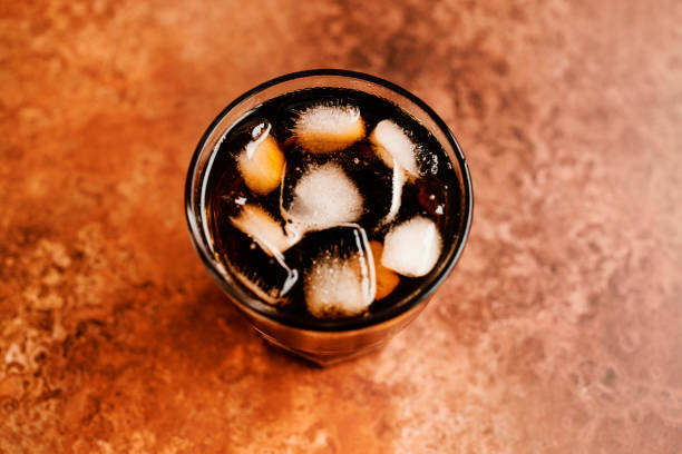 istock Glass of Iced black coffee against a copper backdrop. 1253421243