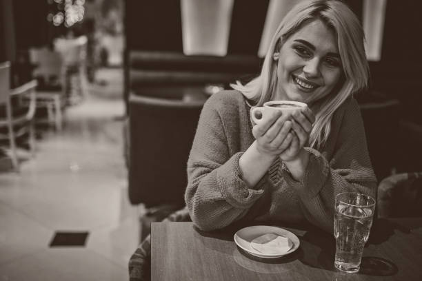istock One beautiful young woman drinking coffee in cafe 1253421891