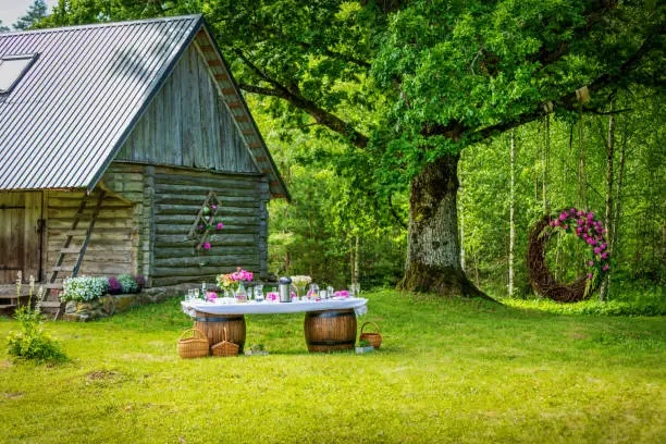 Photo of beautiful wedding banquet buffet table and decorations in rustic style in the country garden