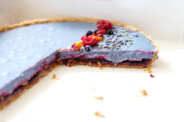 Cut homemade cake decorated with freeze- dried berries. Photo
