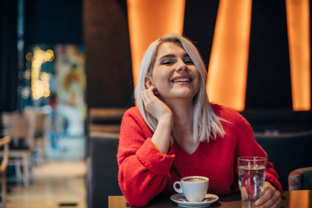 istock One beautiful woman drinking coffee in cafe 1253422002