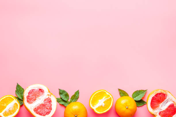 istock Citrus fruits on pink background top view 1253422190