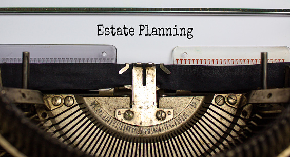 Text 'estate planning' typed on retro typewriter. Business concept.