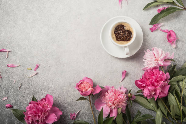 istock Note book, peonies and cup of coffee on light concrete backgrounds 1253424345