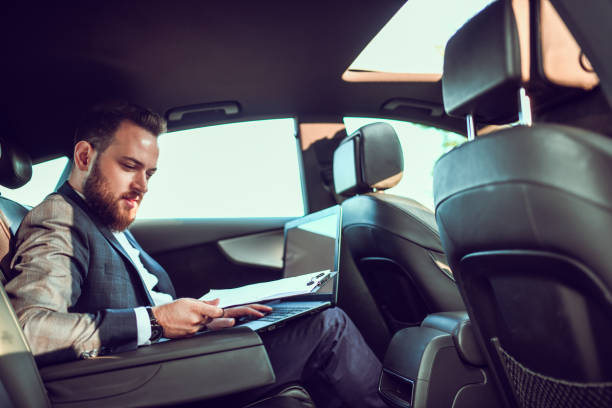 istock Bearded Handsome Businessman Working In Modern Car 1253424673