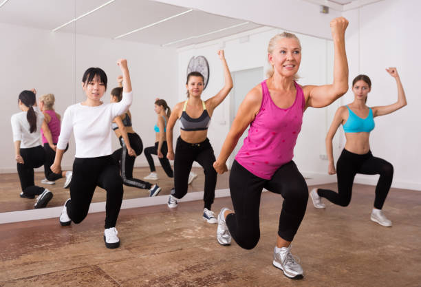 istock Fitness women practicing zumba movements 1253425457