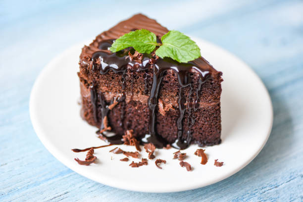 istock Cake chocolate sauce delicious dessert served on the table - cake slice on white plate with topping chocolate and mint leaf 1253426131