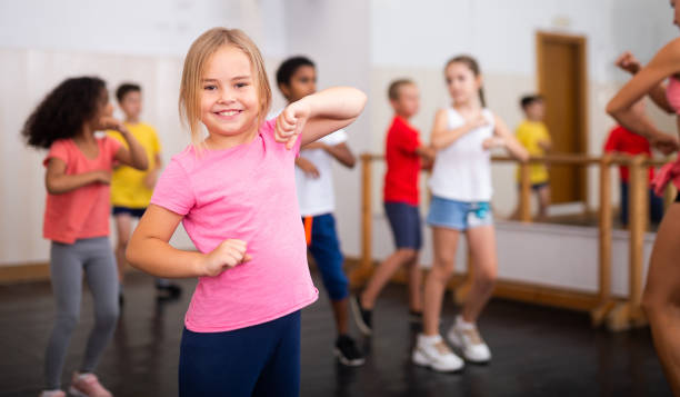 istock Girl exercising in group during dance class 1253426194