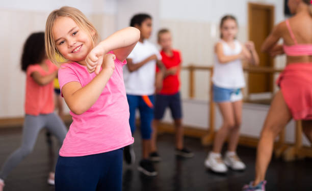 istock Girl exercising in group during dance class 1253426195