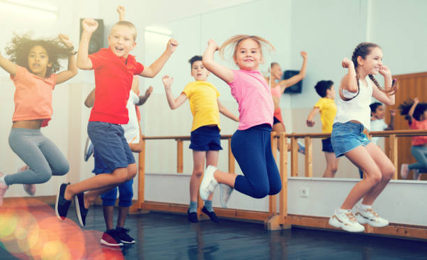 istock Boys and girls jumping in dance studio 1253426244