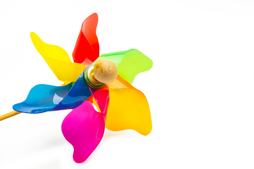 A colored pinwheel on a white background with copy space in a close up view
