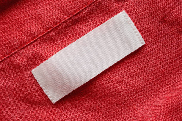 blank clothing tag label on linen shirt fabric texture background - scale industry copy space special imagens e fotografias de stock