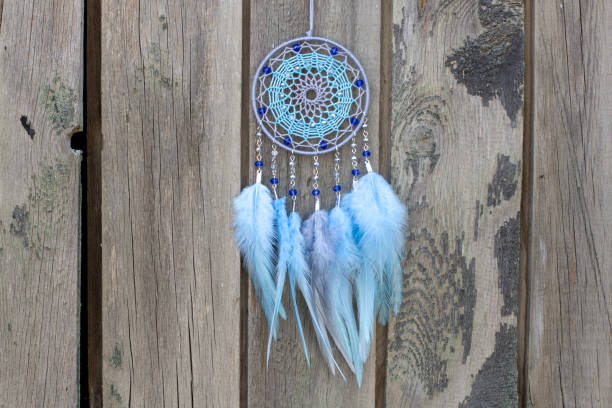 istock Handmade dream catcher with feathers threads and beads rope hanging 1253429532